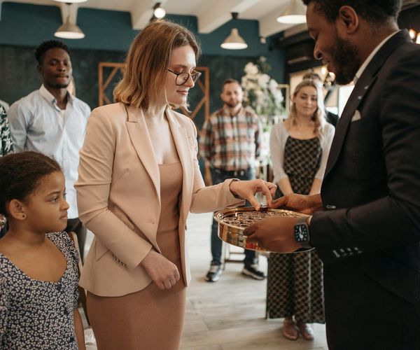 Diverse group of smiling people in a comfortable, welcoming environment.